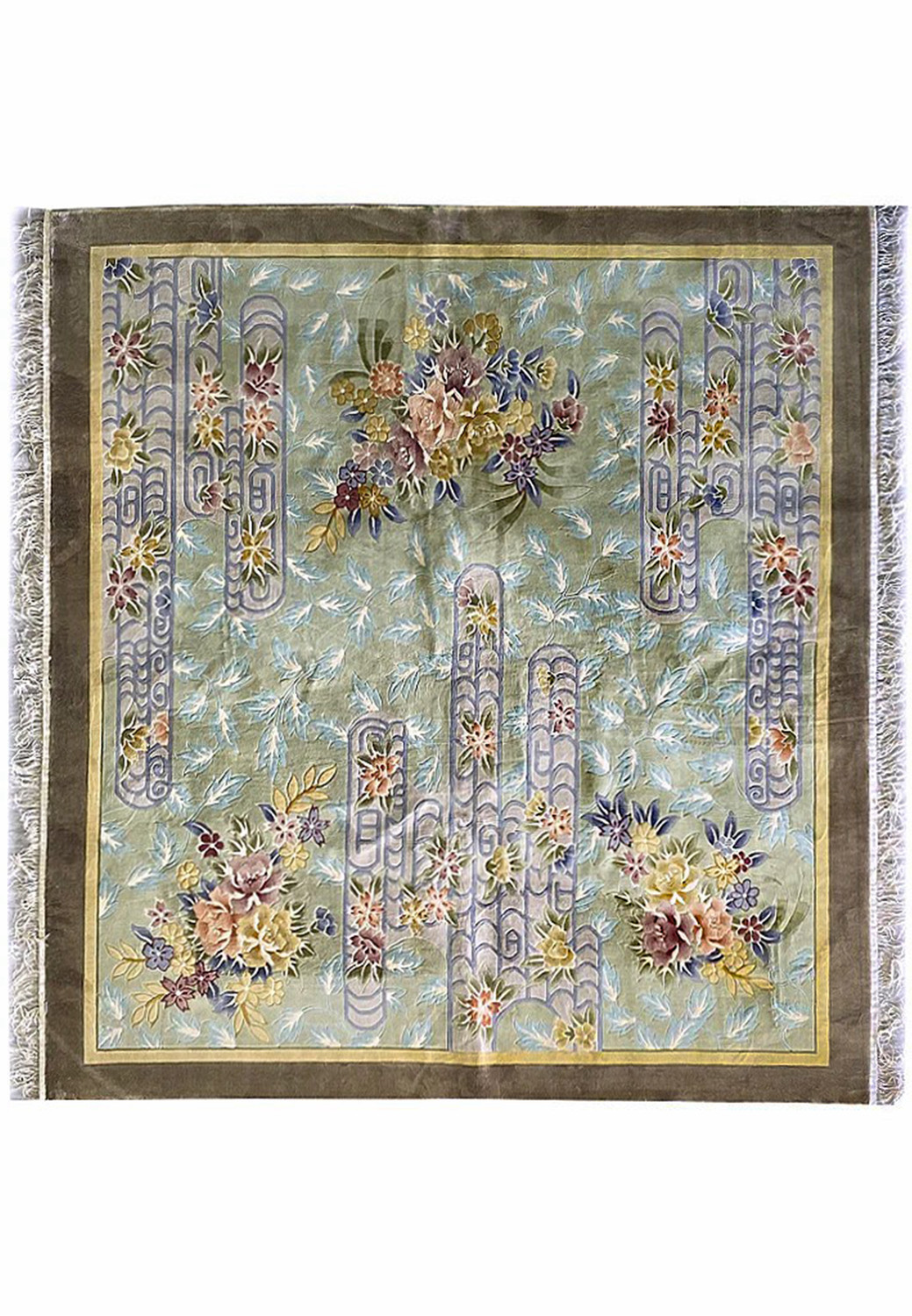 Full view of the 8x8 Vintage Oriental Art Deco Square Rug showing its sage green background, pastel blue scrollwork, and multi-colored floral bouquets hand-knotted in wool with taupe border and ivory fringe.