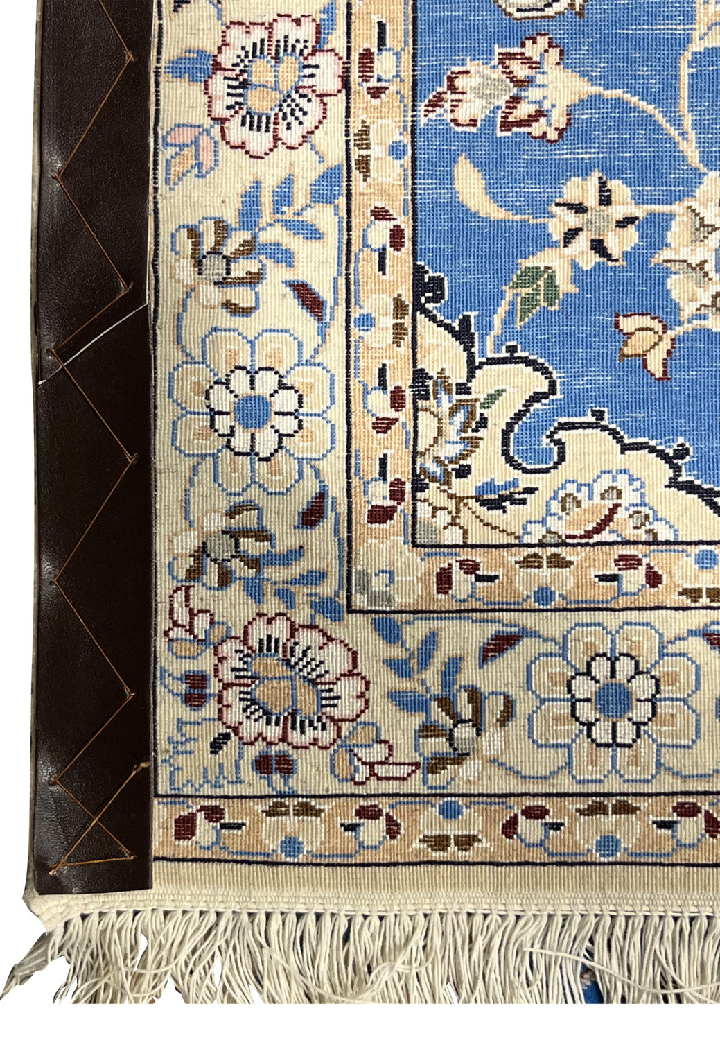 Corner of 2'8 x 17'2 Persian Nain 6LA Runner backside with leather reinforcement, ivory fringe, and floral border details.