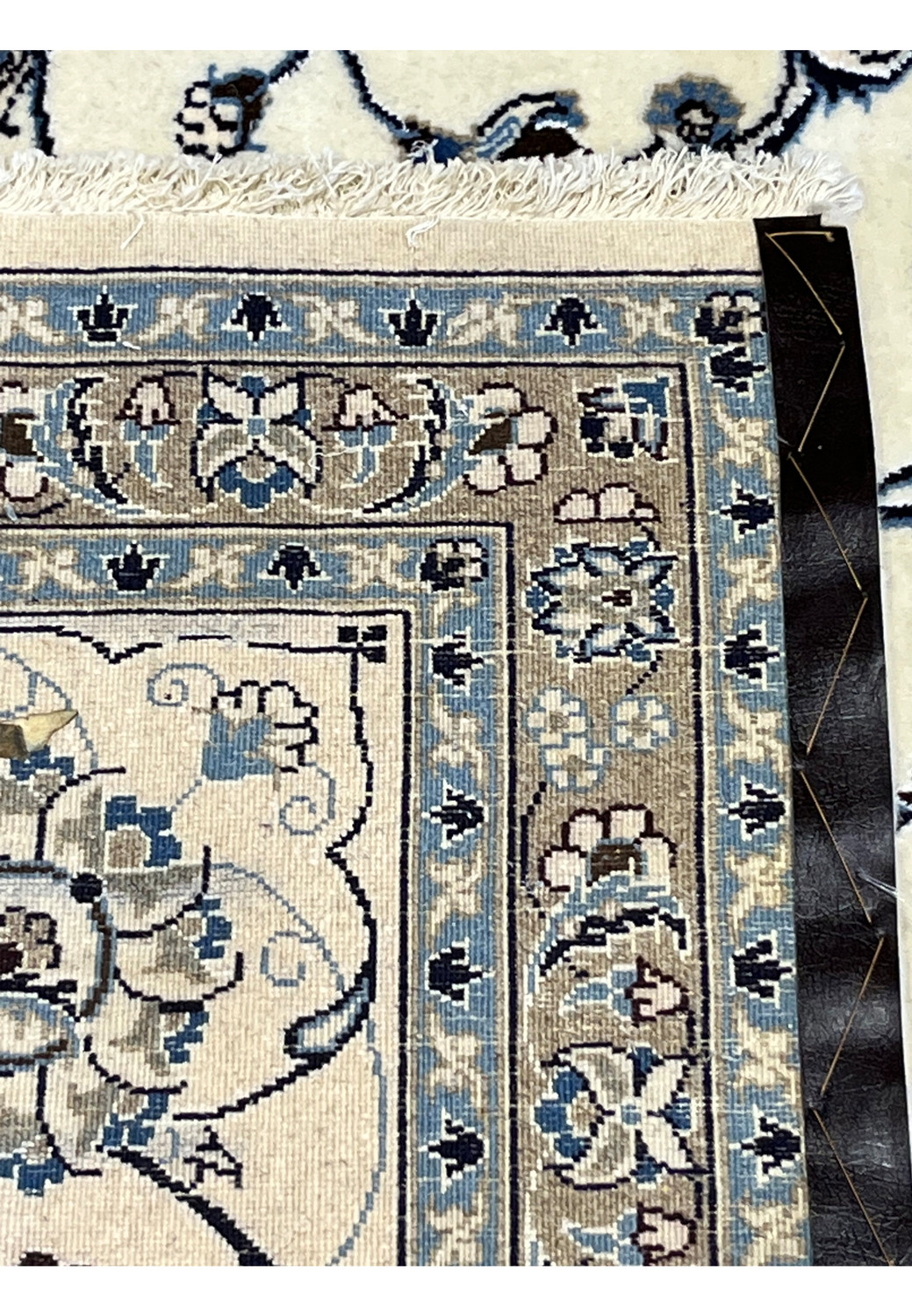 Backside of 10x13 Persian Nain 9LA Rug showing precise hand-knotted construction with cotton foundation and blue-taupe detailing.