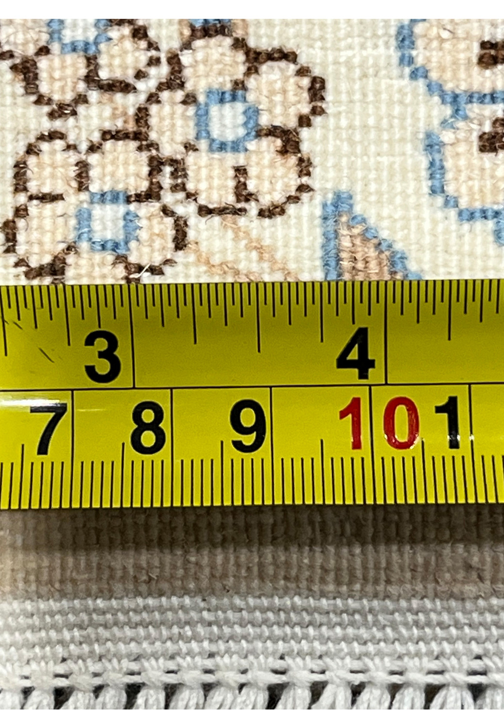 Measuring ruler on backside of Persian Nain 6 LA rug showing tight knot count per inch, ivory foundation, and authentic hand-woven Persian craftsmanship.
