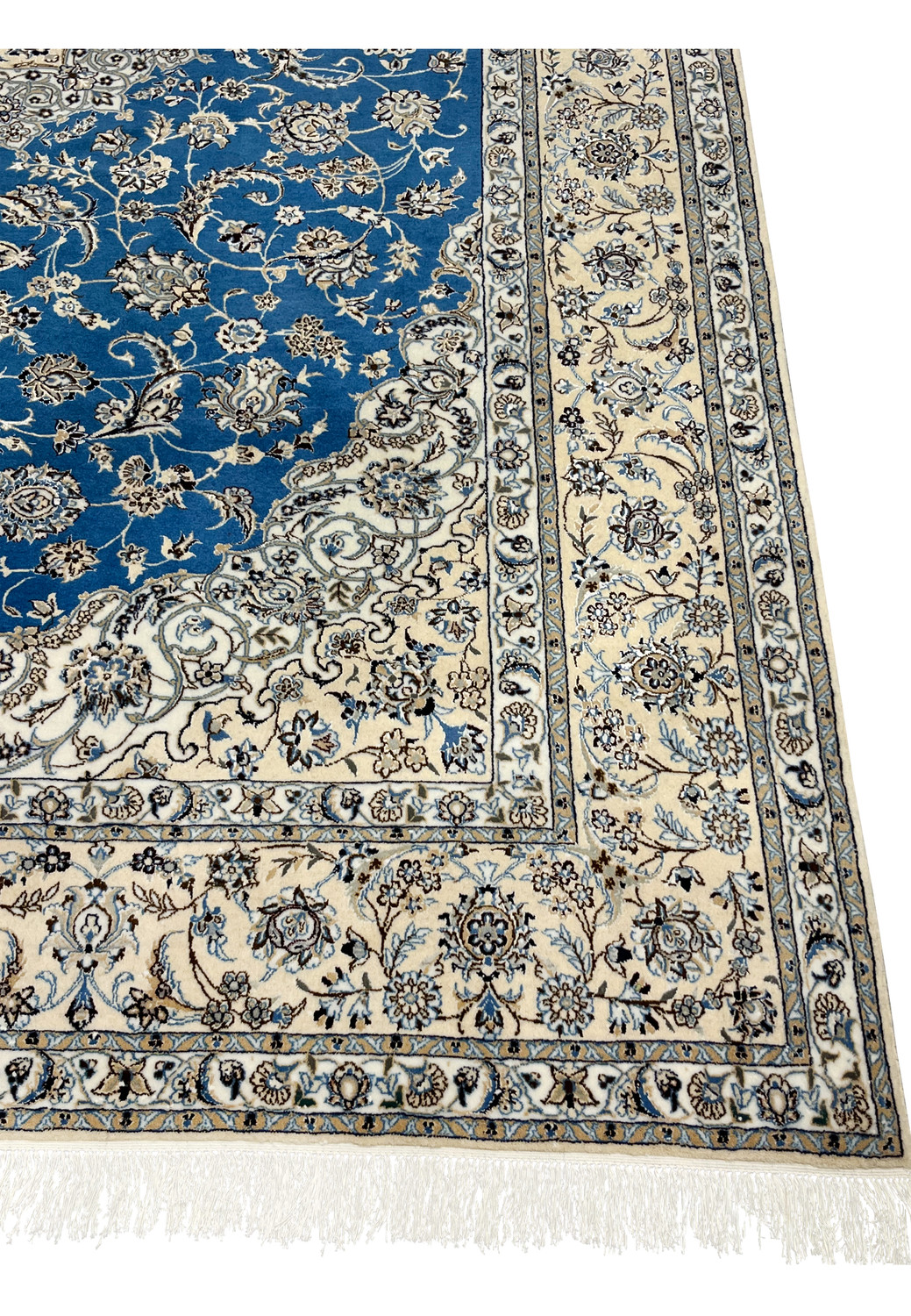 Border detail of Persian Nain rug with ivory and light blue floral patterns on beige background.