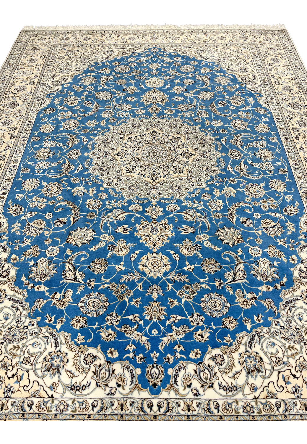 Midfield close-up of royal blue Persian Nain 6 LA rug highlighting silk accents and floral details.