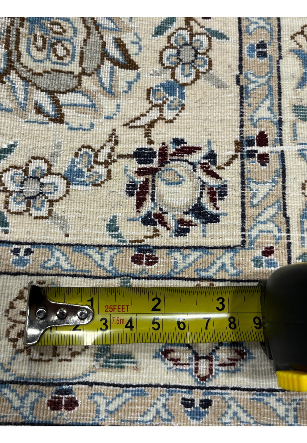 Measurement view of Nain 6 LA rug back showing knot density with ruler.