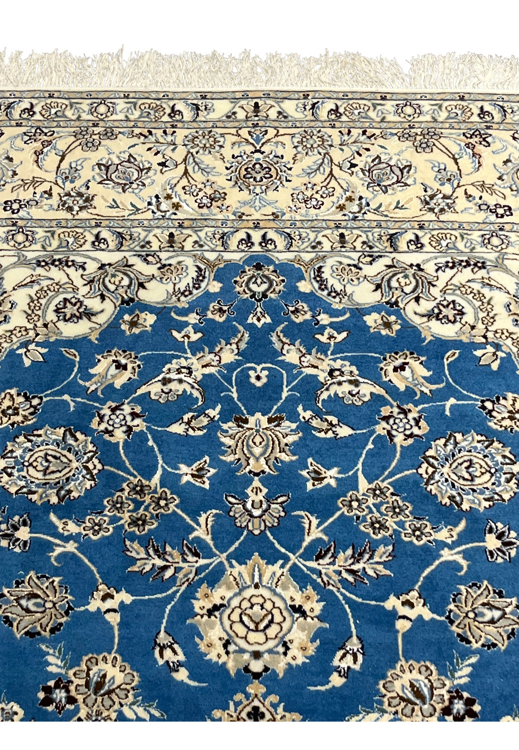 Royal blue field with ivory border and floral vines on Persian Nain rug upper section.