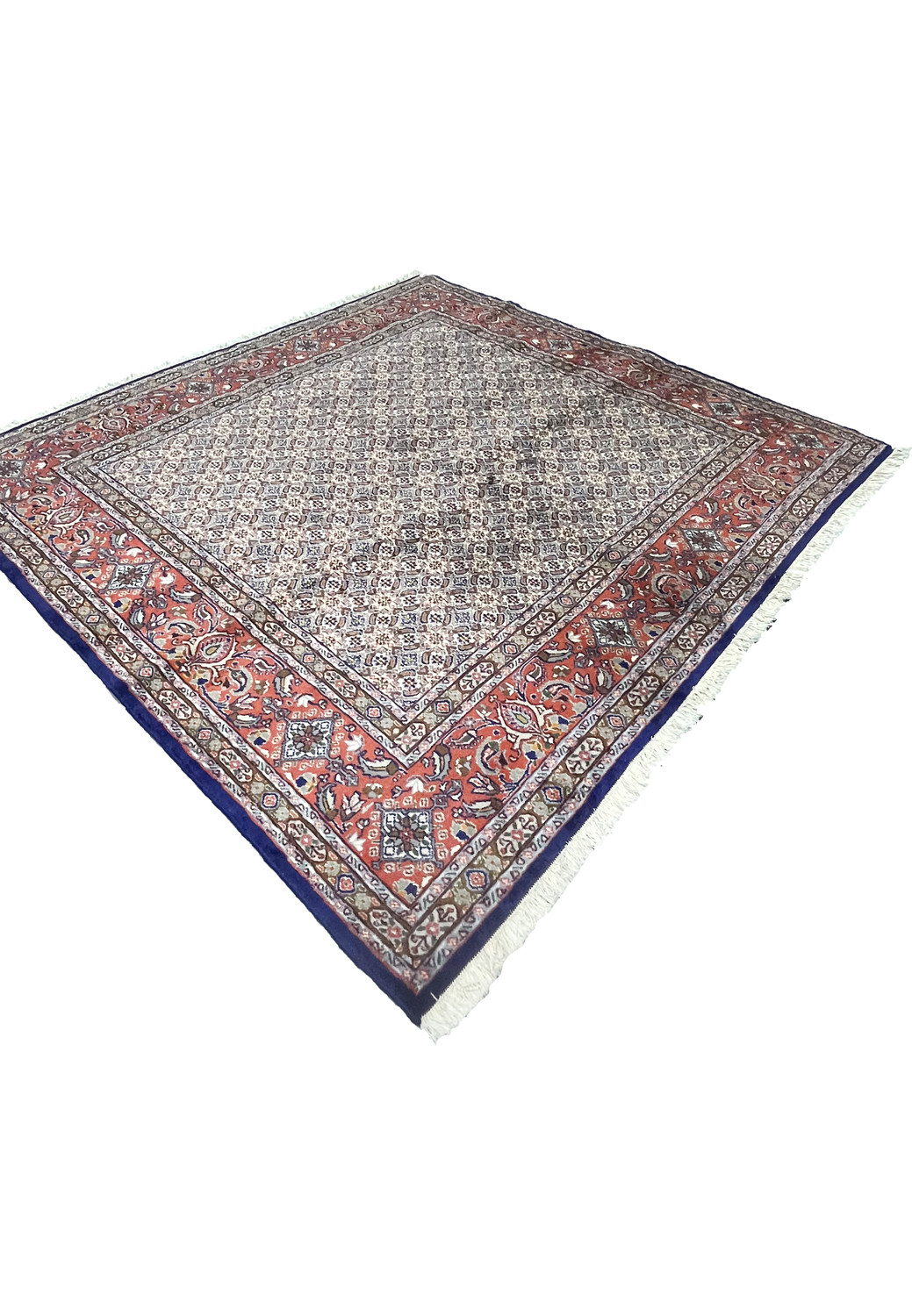 Angled view of Persian Moud rug revealing depth of weave and contrast between field and borders.