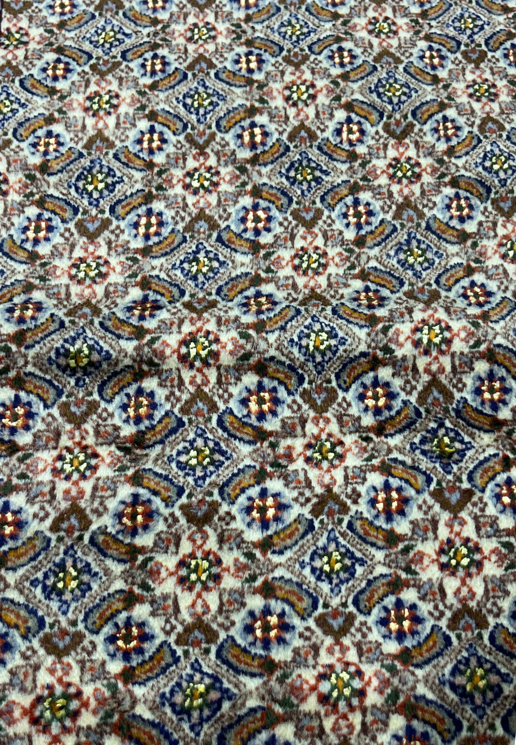 Detailed Herati fish pattern with blue rosettes and olive-green leaves on ivory field of Moud rug.