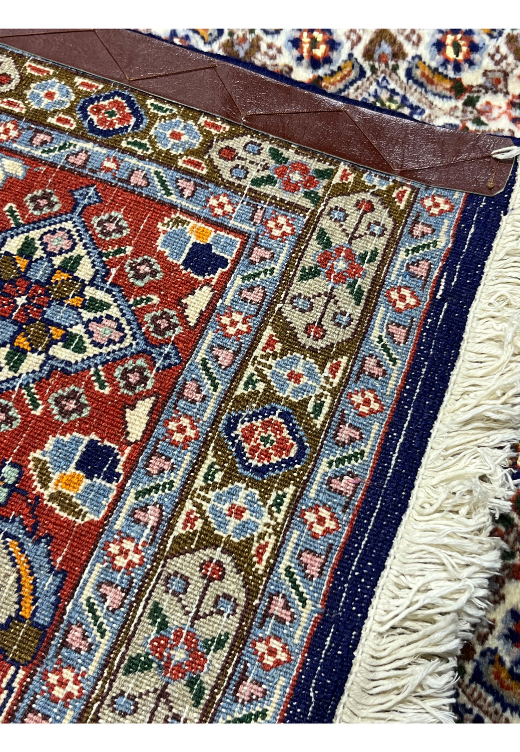 Back of hand-knotted Moud rug with visible cotton foundation and fine knot density.