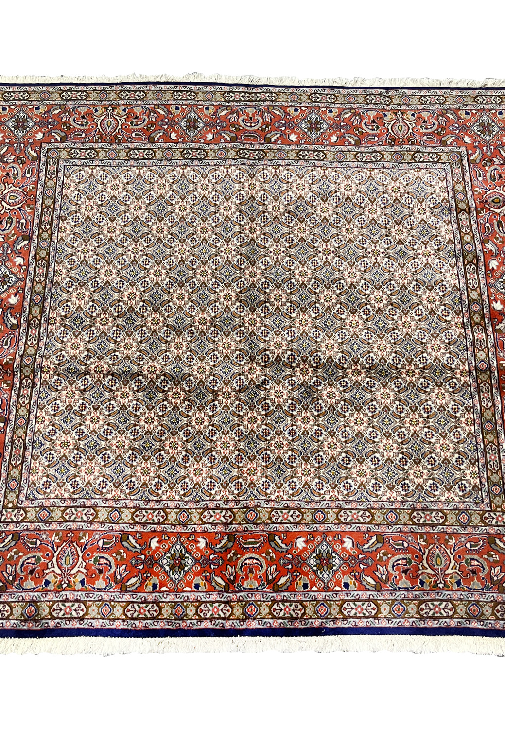 Hand-knotted Persian Moud rug laid flat, displaying balanced lattice pattern and coral-red border.