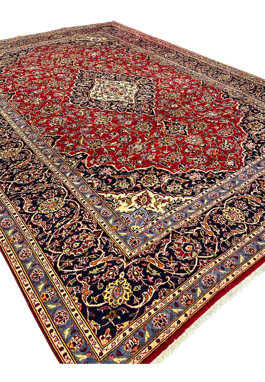 Angled perspective of 9x13 Persian Kashan rug showing border discoloration