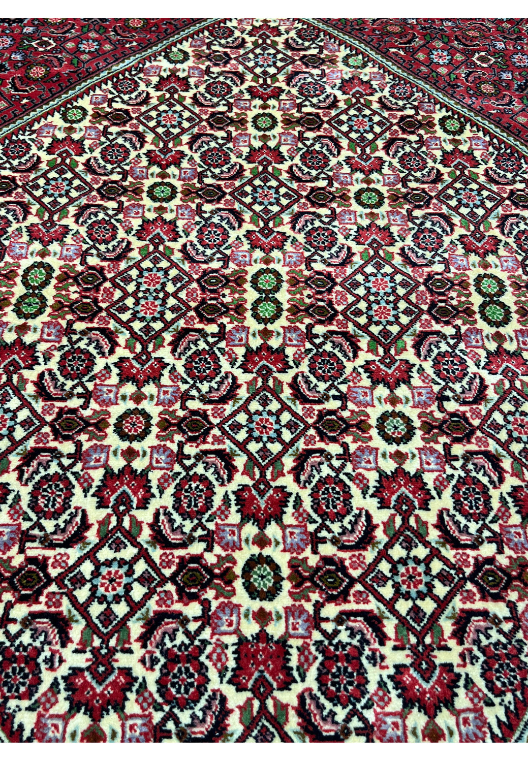 closeup of 10x13 Bijar Persian rug medallion showing intricate red, ivory, and green motifs