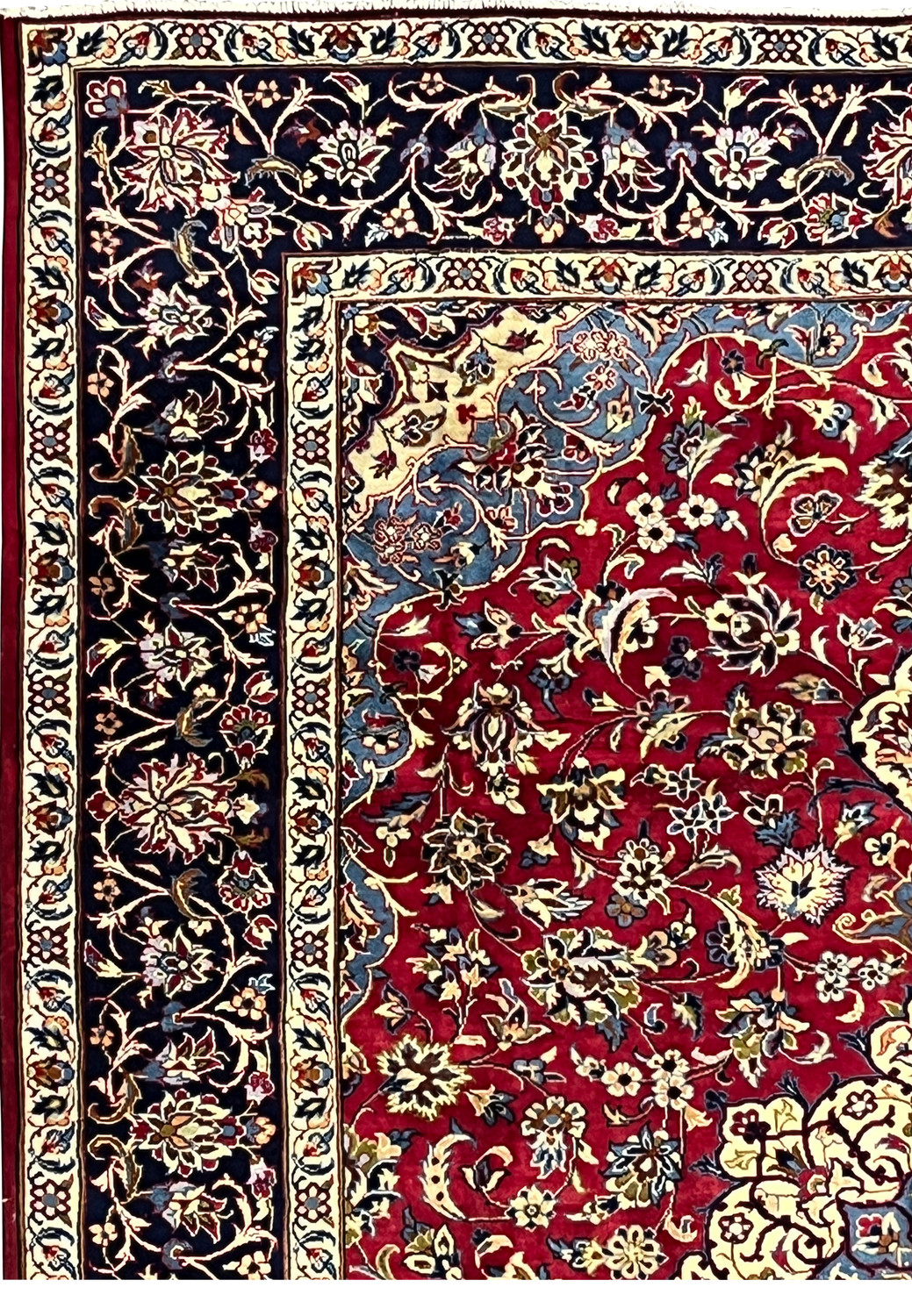Border of 8'5 x 11'8 Persian Isfahan rug showing navy vines, ivory outlines, and detailed blossoms.