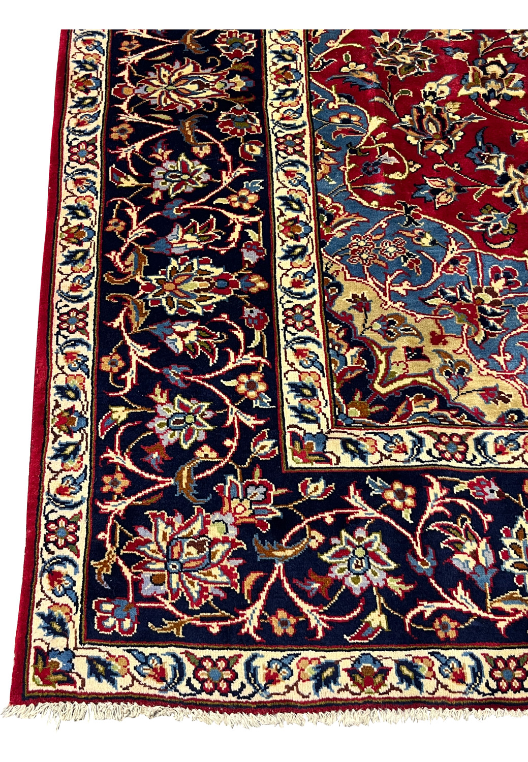 Corner detail of 8'5 x 11'8 Persian Isfahan rug showing blue corner, ivory edge, and floral border.