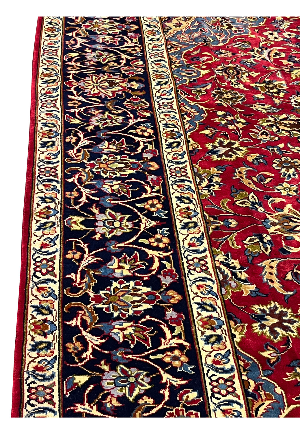 Side border of 8'5 x 11'8 Persian Isfahan rug showing navy floral vines and ivory guard stripes.