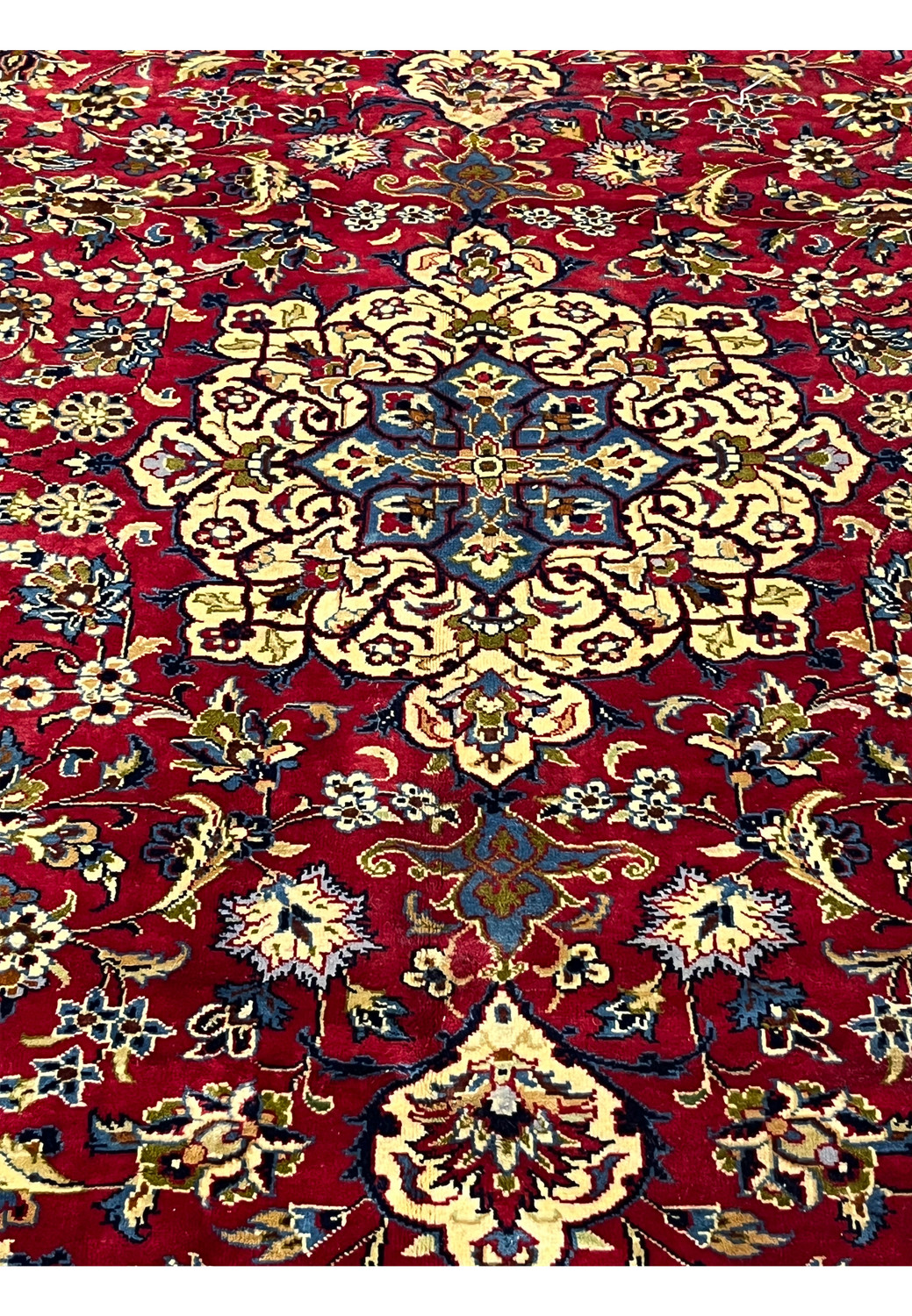 Closeup of 8'5 x 11'8 Persian Isfahan rug highlighting red wool field and multicolor floral details