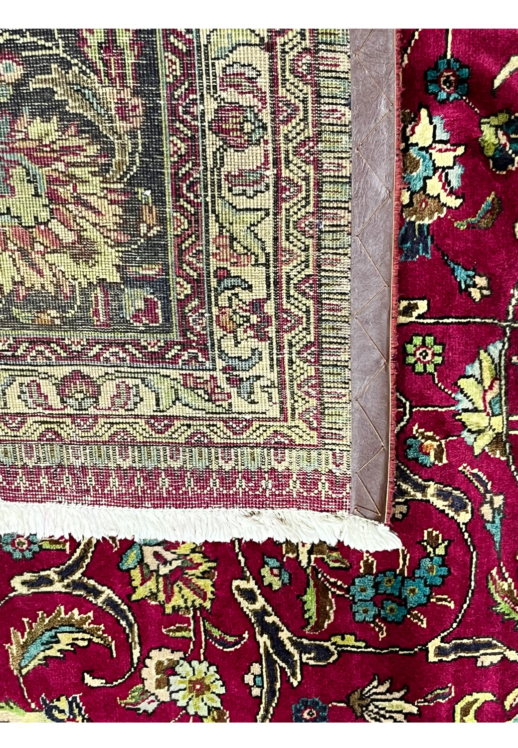 Backside view of the 9'9 x 12'4 Persian Tabriz rug showing tight handwoven knots, cotton foundation, and original fringe with intricate border design.