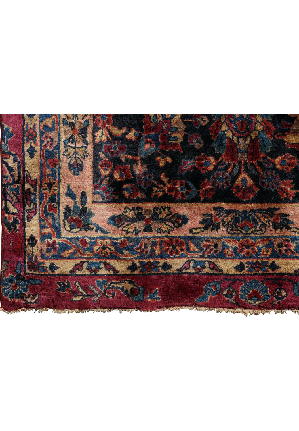 Close-up of original uneven fringes on antique Persian Kashan rug with soft wool pile and detailed floral corner border.