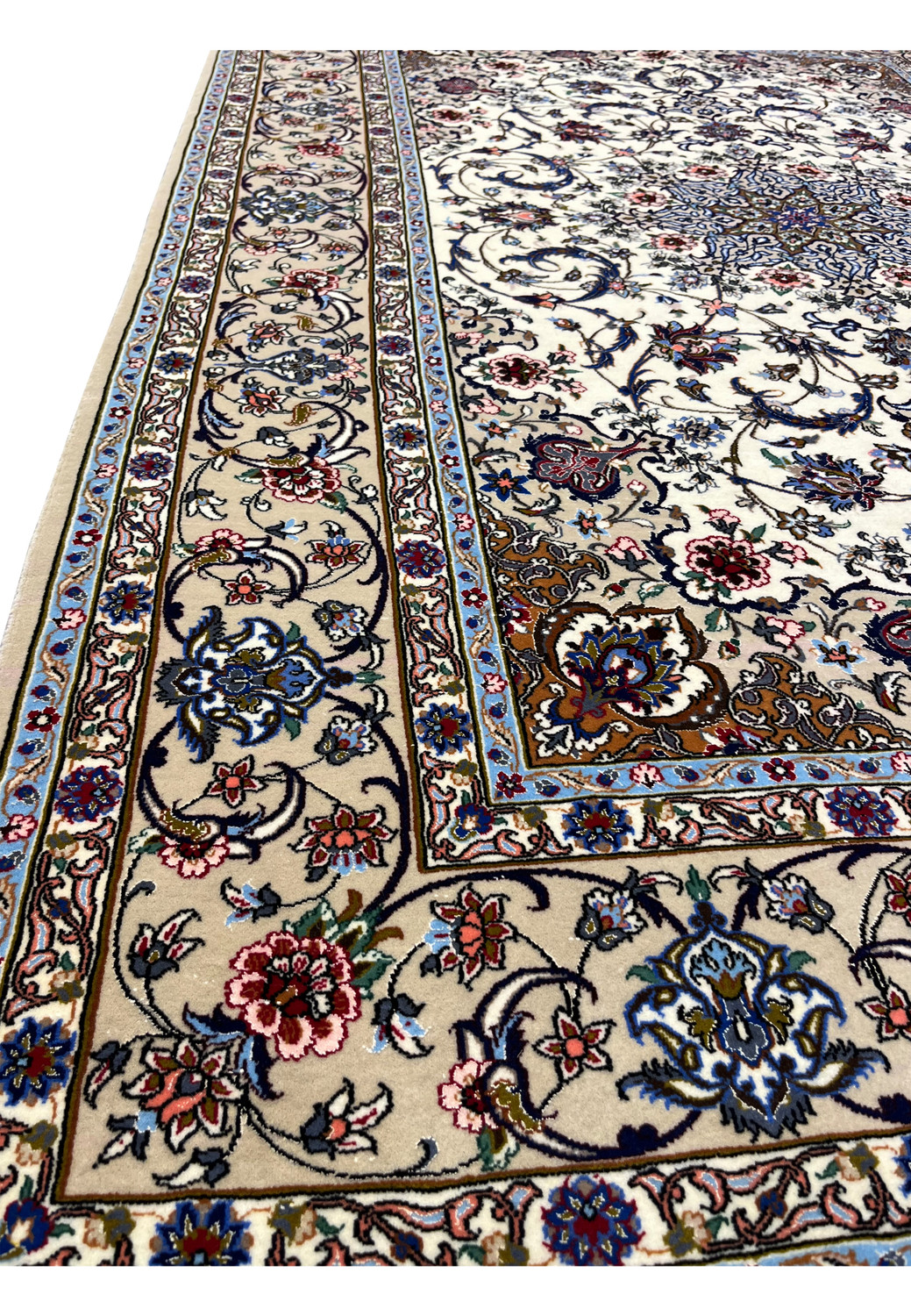 Side view revealing rug texture, silk highlights, and dense floral motifs on ivory background.