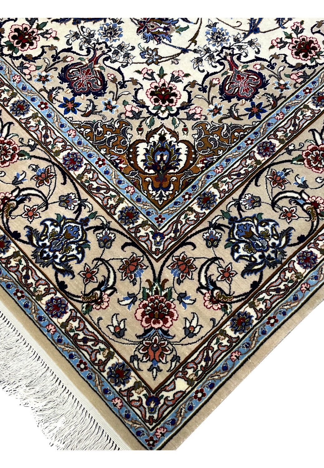 Detailed corner and fringe view showing beige borders, blue accents, and fine floral work of the Isfahan rug.