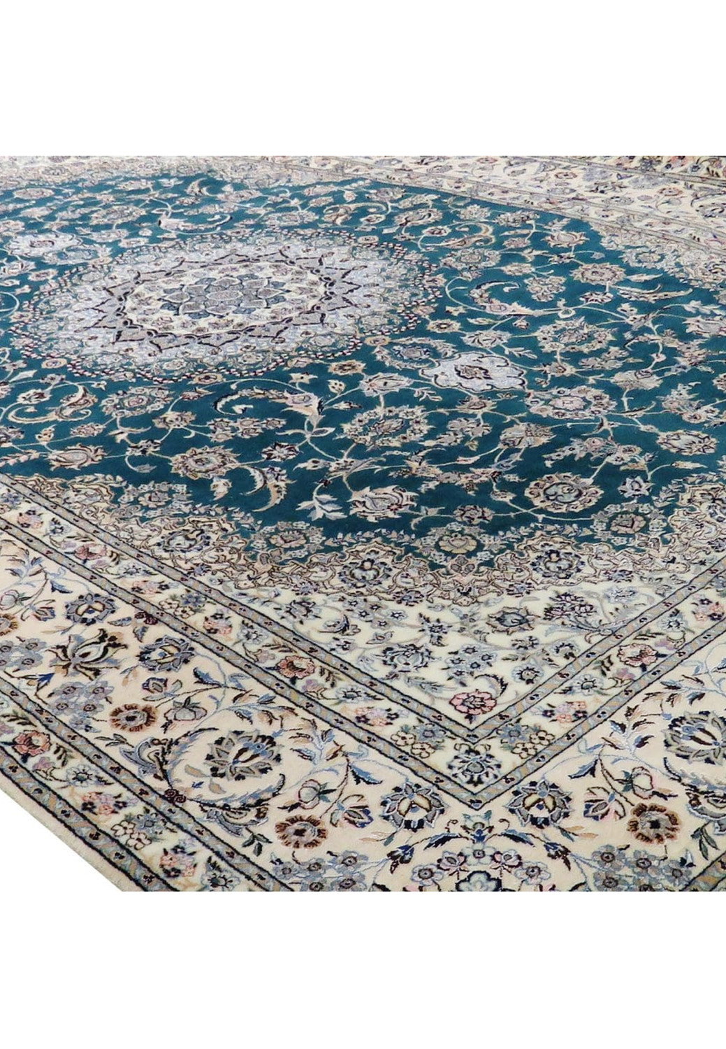 Angled view of the deep teal-green Persian Nain 6La rug showing the floral medallion and cream borders in wool and silk.