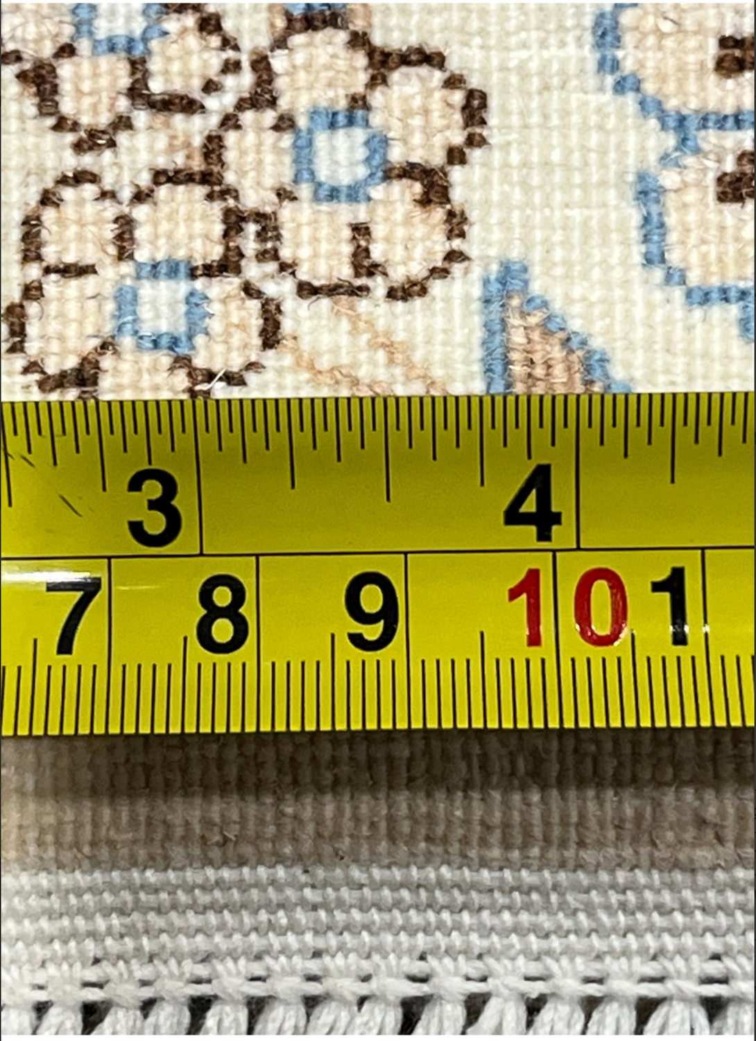 Backside of the deep teal Persian Nain rug with a ruler showing its fine 6La knot density and precise wool-and-silk weaving detail.