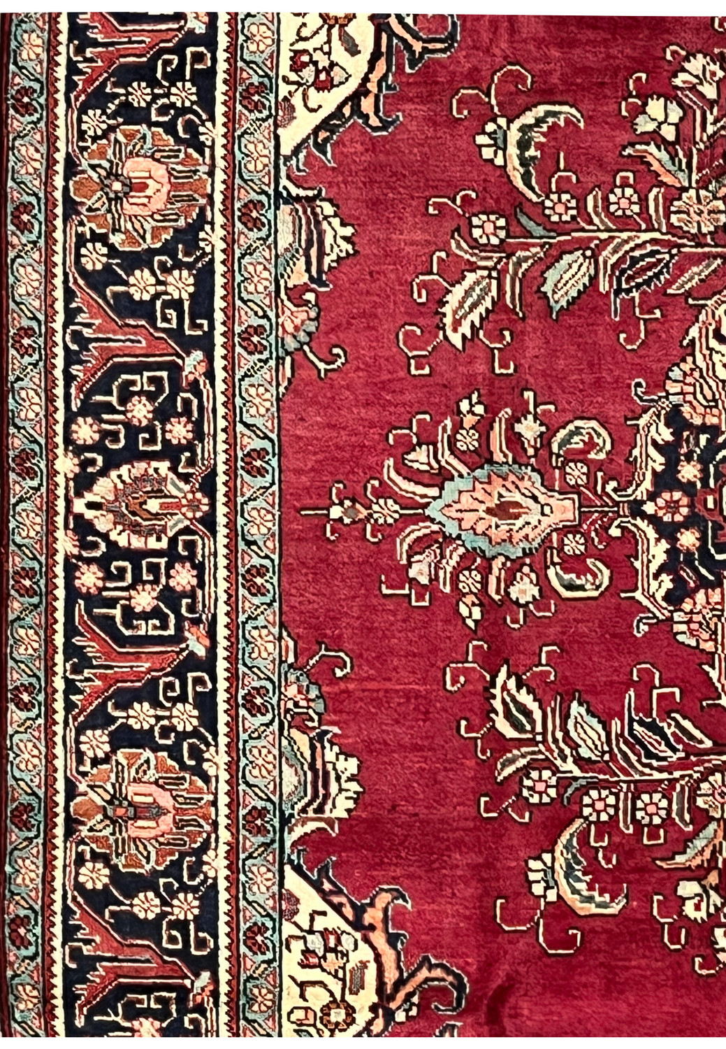 Side view of the 10x13 Patina Vintage Tabriz Rug showing worn areas, floral designs, and border contrast.