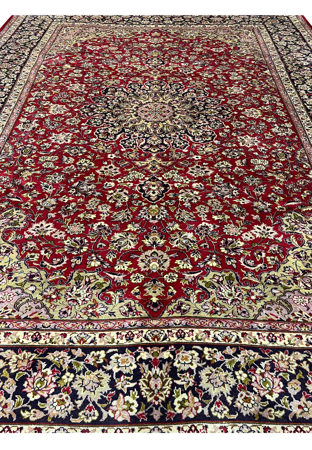 Color closeup of red field Persian Isfahan rug showing detailed floral weaving