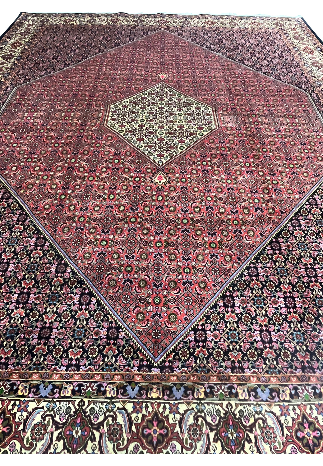 Top view of Persian Bijar iron rug highlighting compact knotting, high density wool construction, and intricate repeating floral lattice