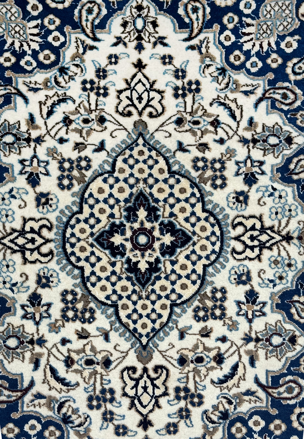 Close up of ivory and powder blue medallion on royal navy blue Persian Nain rug with mocha brown outlines and floral rosette pattern