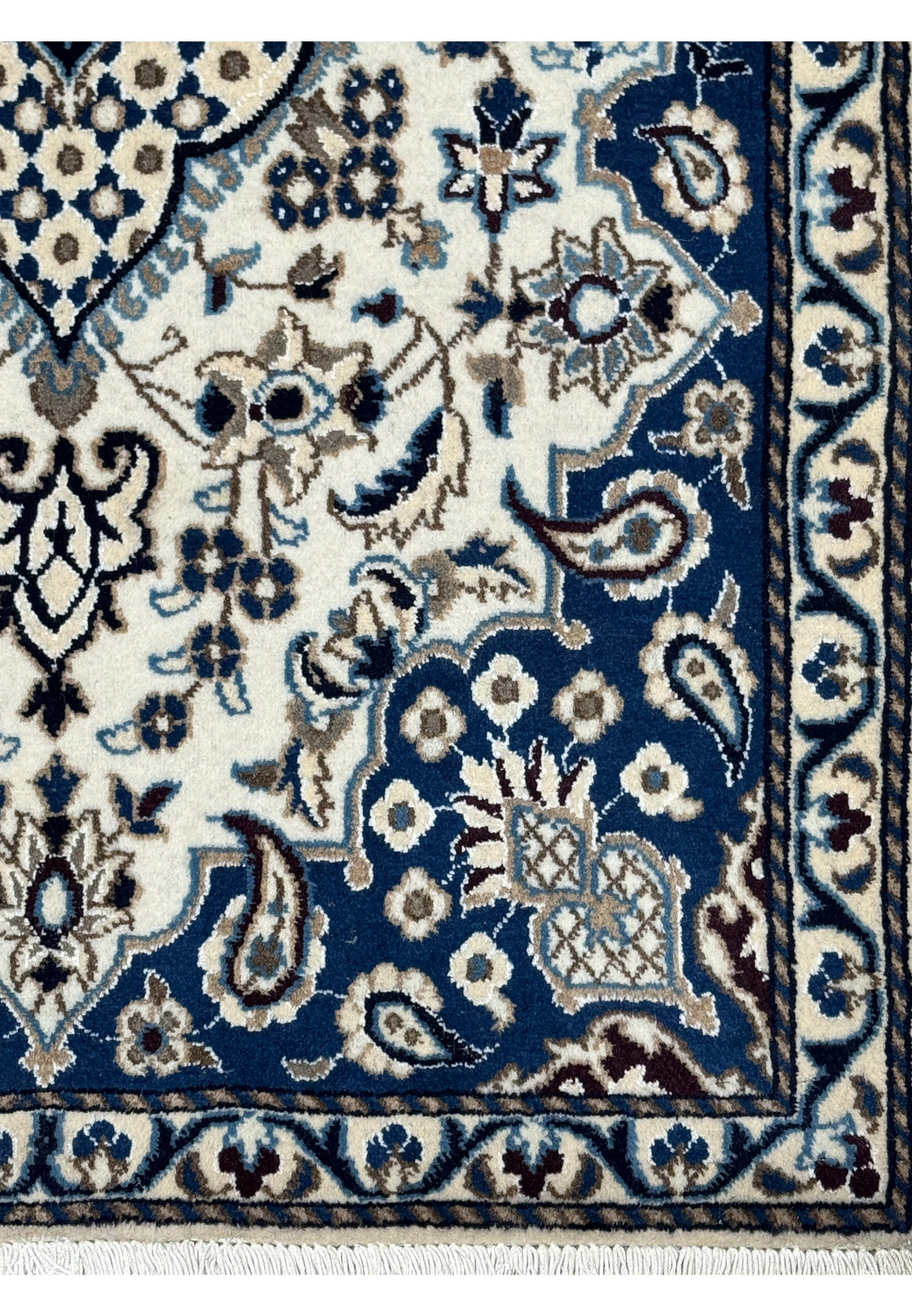Border detail of Persian Nain rug with royal navy blue background, ivory floral motifs, powder blue accents, and scrolling vine patterns