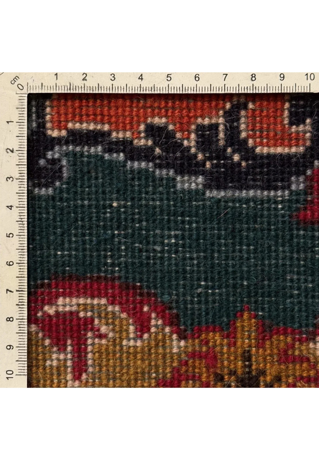 Upper section of Persian Tabriz rug showing floral cartouches in coral, teal and slate blue tones