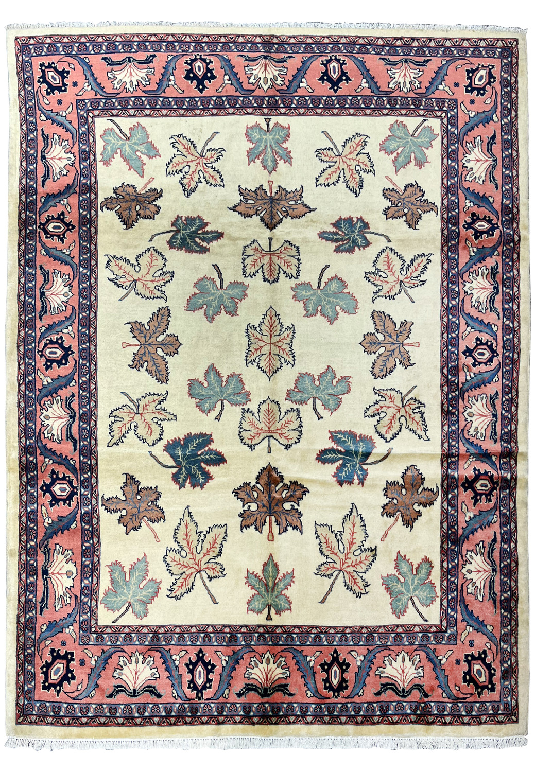 Full view of a hand knotted Persian Farahan rug with ivory field, allover leaf motifs, and salmon pink botanical border