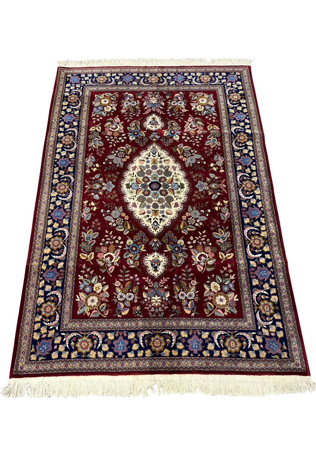 Top view of Persian Isfahan rug showing symmetrical medallion design and detailed floral field