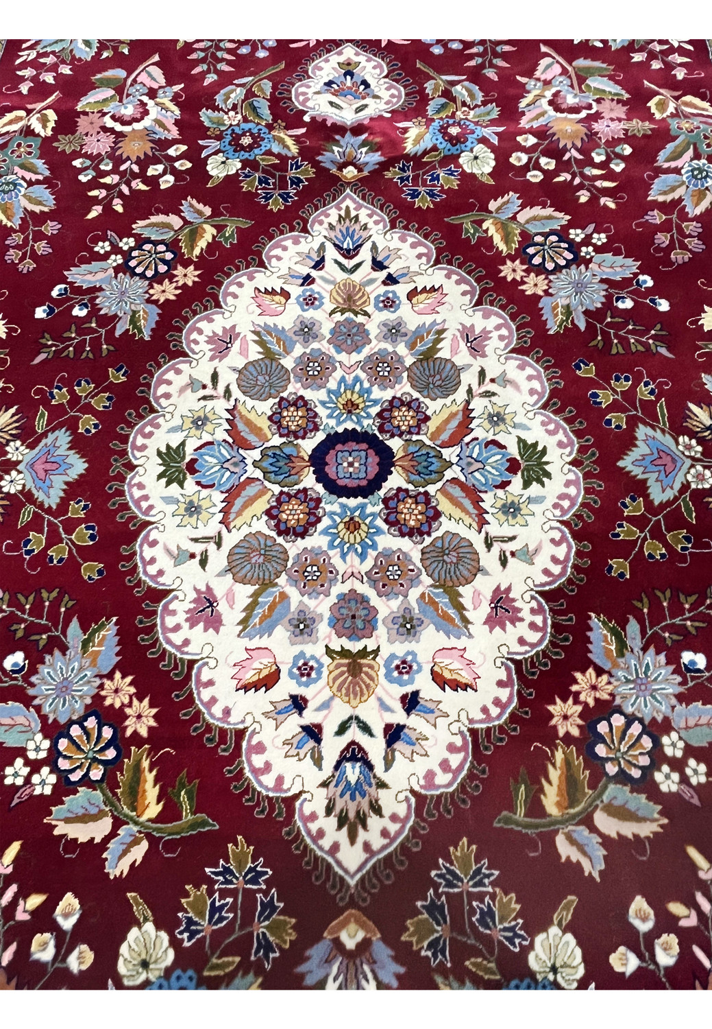 Close-up of ivory central medallion on Persian Isfahan rug with intricate silk floral detailing