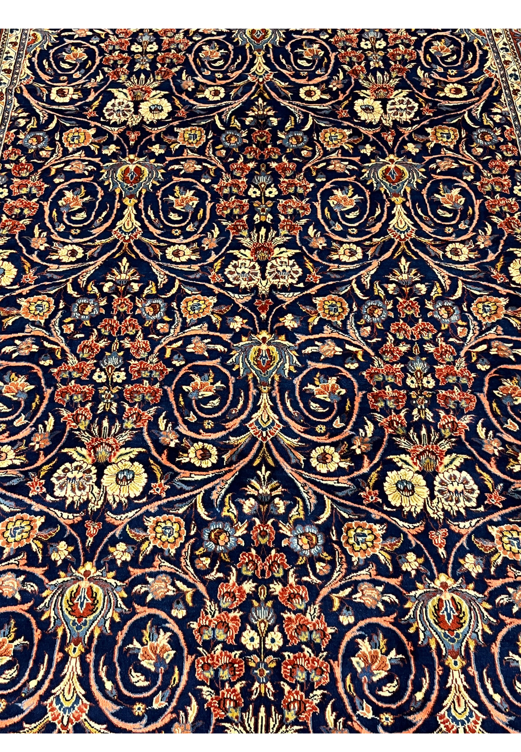 Central floral arrangement detail on navy Persian Sarough rug