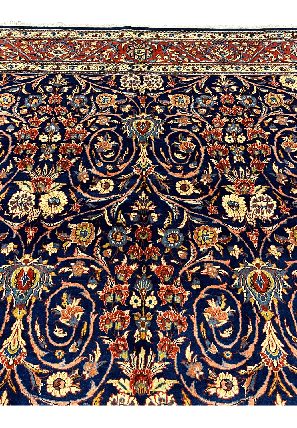 Upper border detail of Persian Sarough rug with red ground, ivory accents, and traditional floral patterns