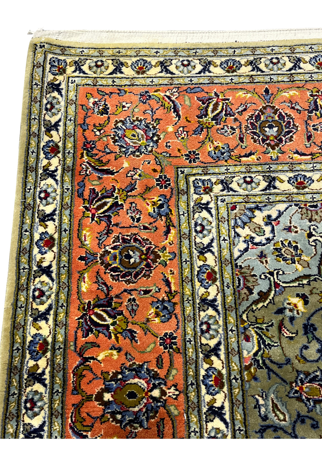 Upper border detail of green Persian Kashan rug with terracotta ground and floral motifs