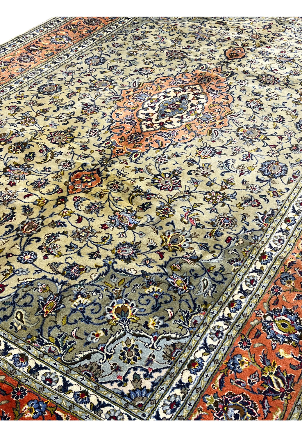 Angled view of green Persian Kashan rug showing pile height and surface texture