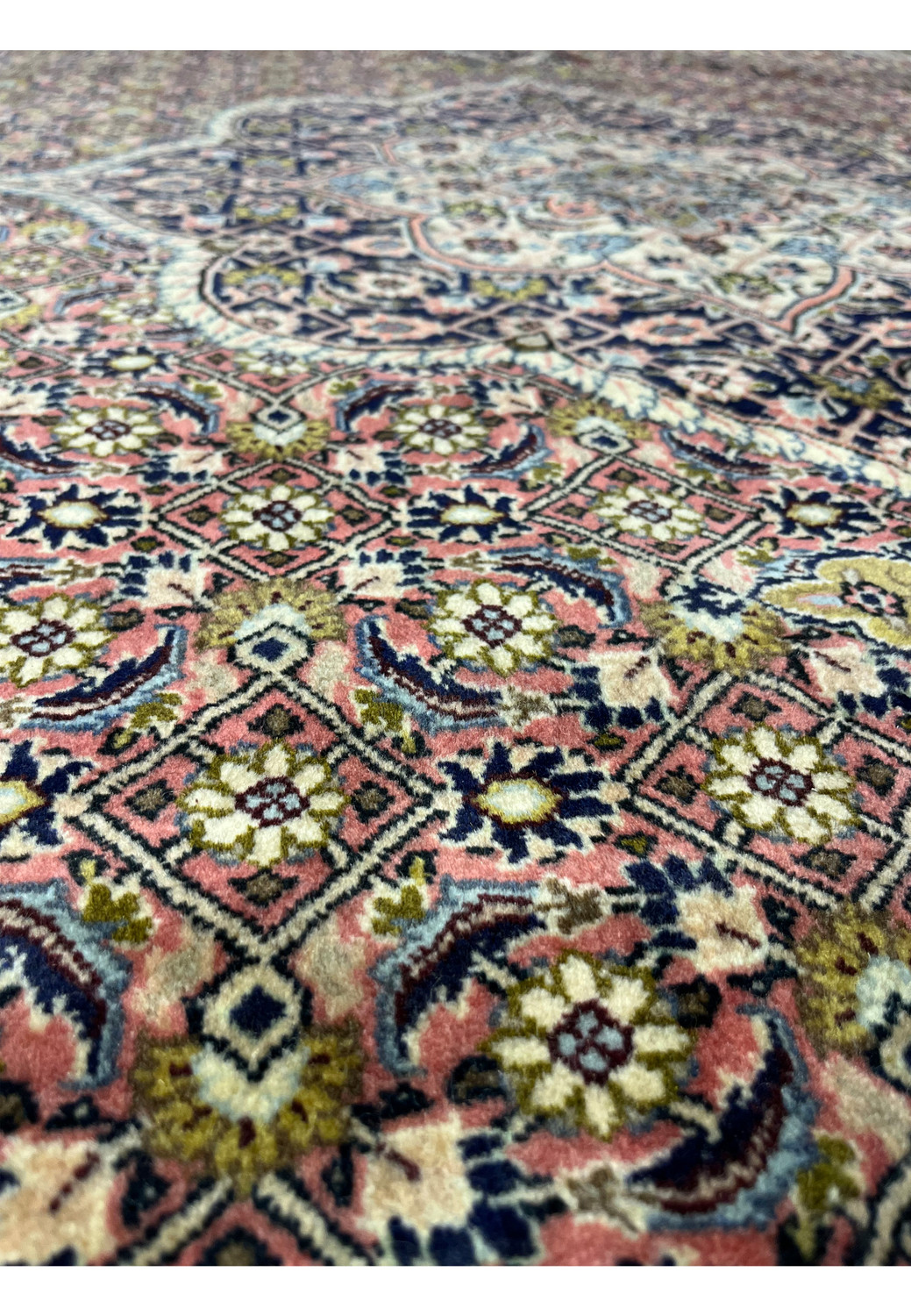 Color close-up of Persian Bijar iron rug showing deep red, navy blue, ivory, and muted green wool tones