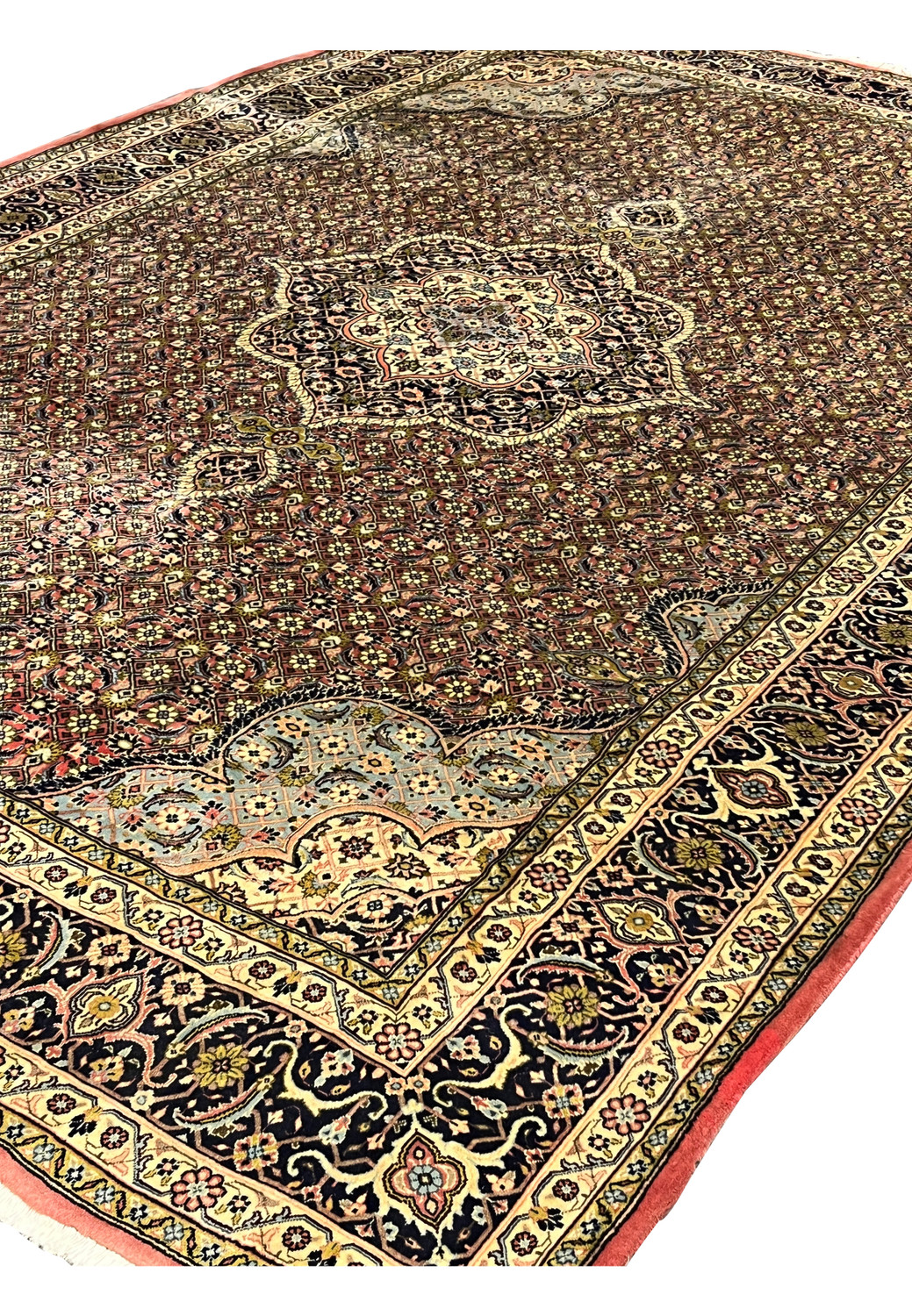 Angled view of Persian Bijar iron rug revealing dense allover pattern, heavy wool pile, and strong structure.