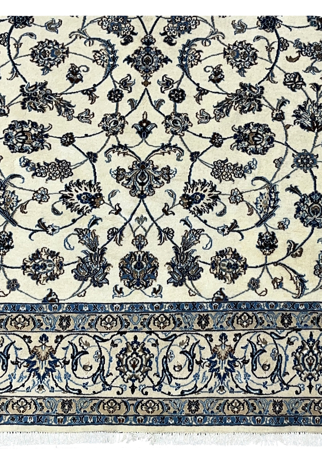 Lower border detail of Persian Nain rug with scrolling floral vines and blue accents