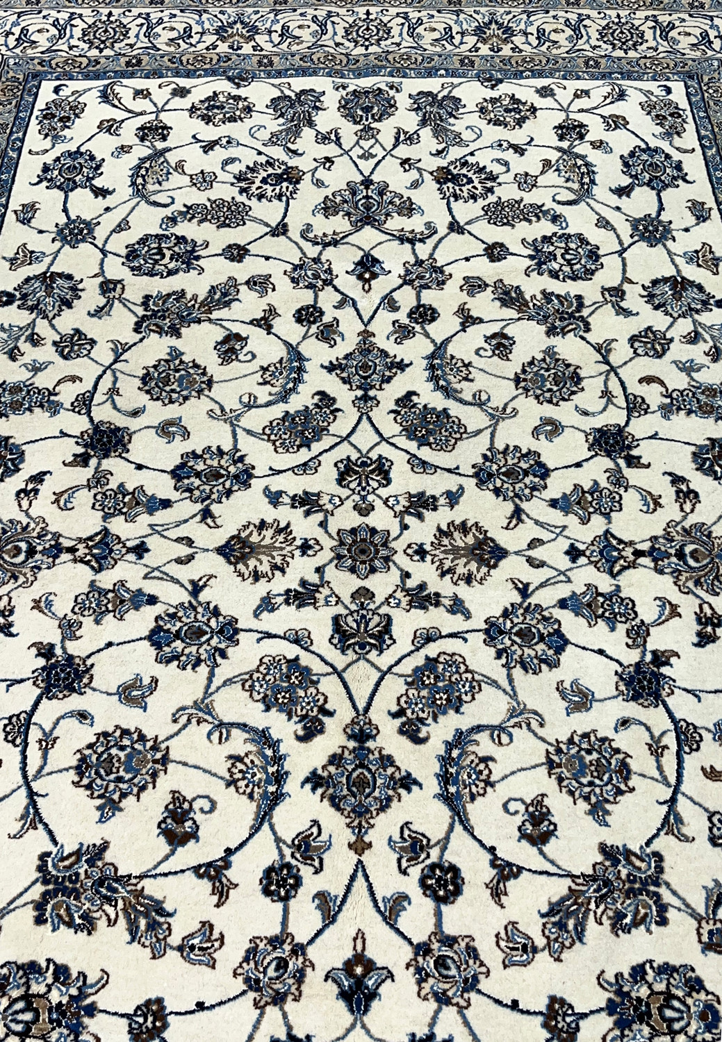 Midfield closeup of Persian Nain rug showing silk highlighted floral rosettes