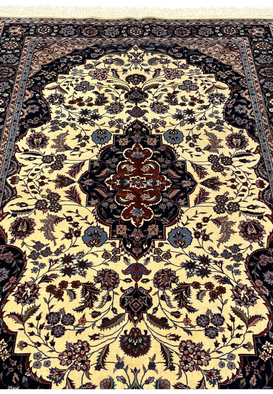 Midfield detail of Persian Tabriz rug showing floral vines around the central medallion