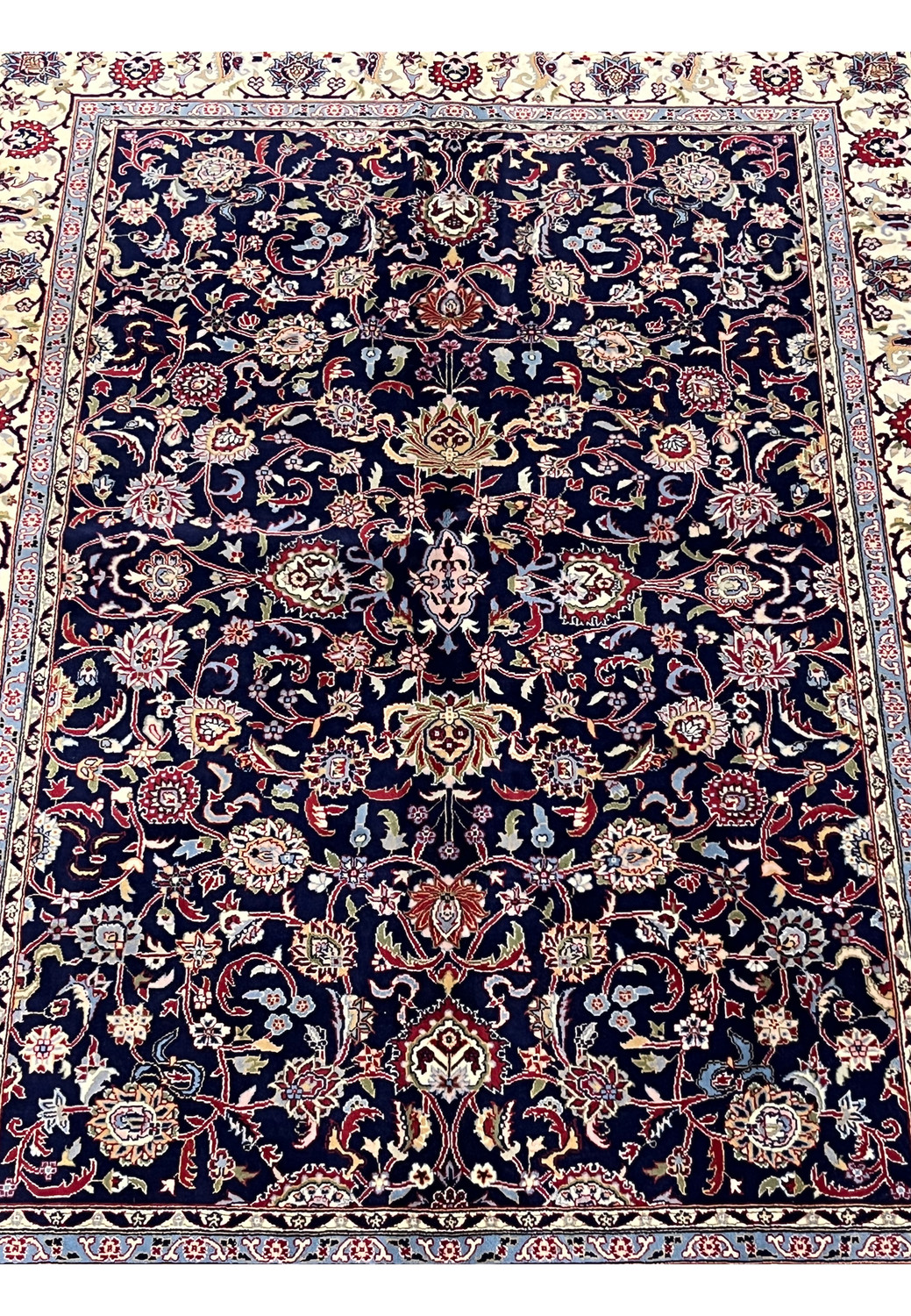 Floral centerpiece detail of Persian Sarough kork rug with layered blossoms on navy field