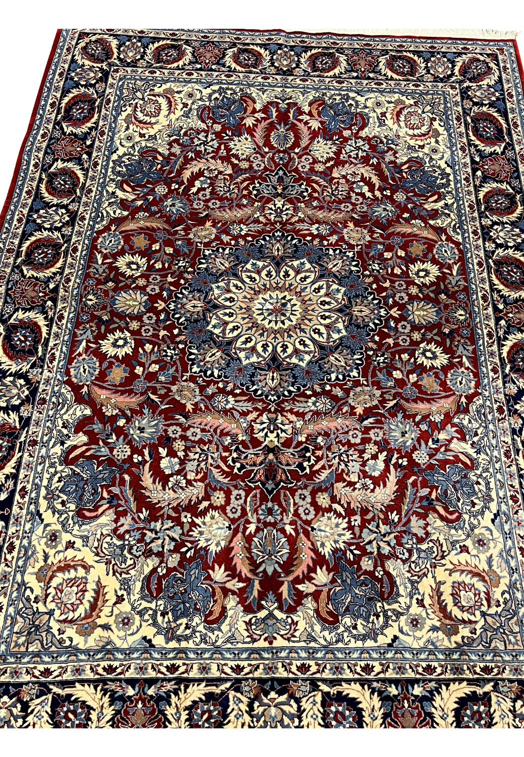 Close view of burgundy field on Persian Tabriz rug with floral vines, palmettes, and light blue and ivory details