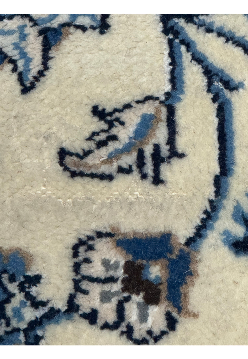 Close-up of Persian Nain rug foundation showing fine knotting and wool pile clarity