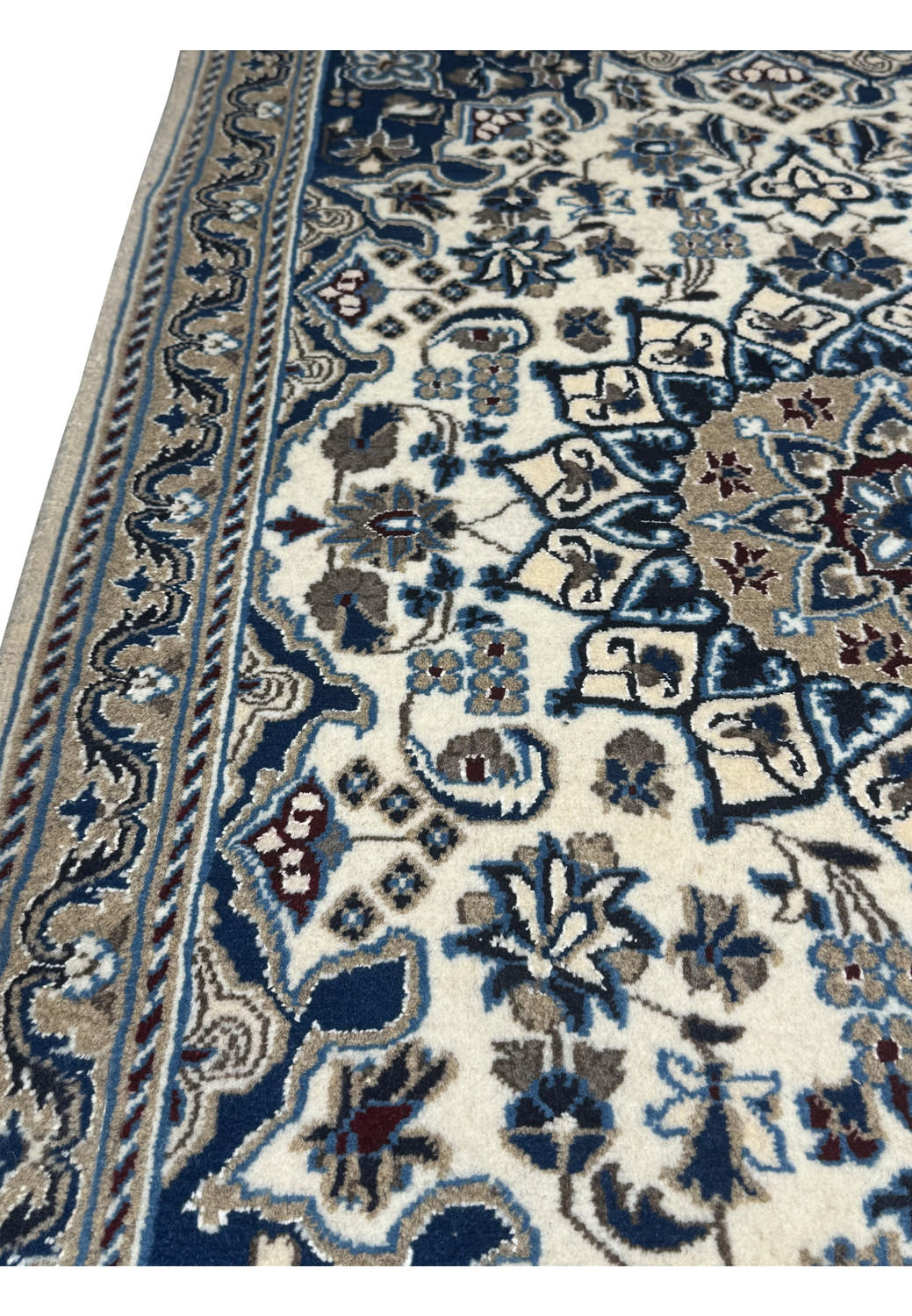Cotton foundation and fine knot structure visible on back of Persian Nain rug