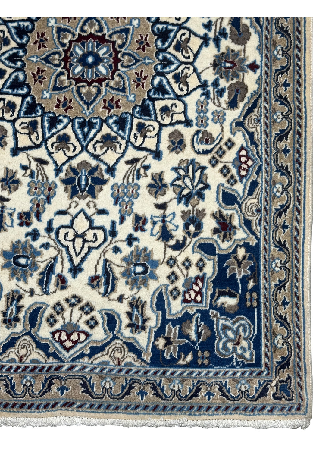 Detailed border view showing navy blue floral arabesques on Persian Nain rug