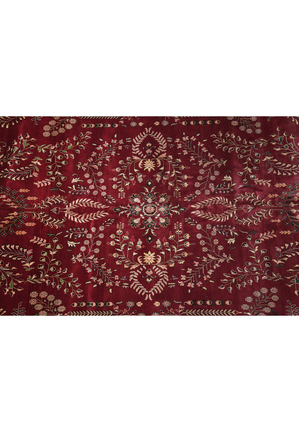 Central floral detail of oversized Sarough rug with deep red wool field