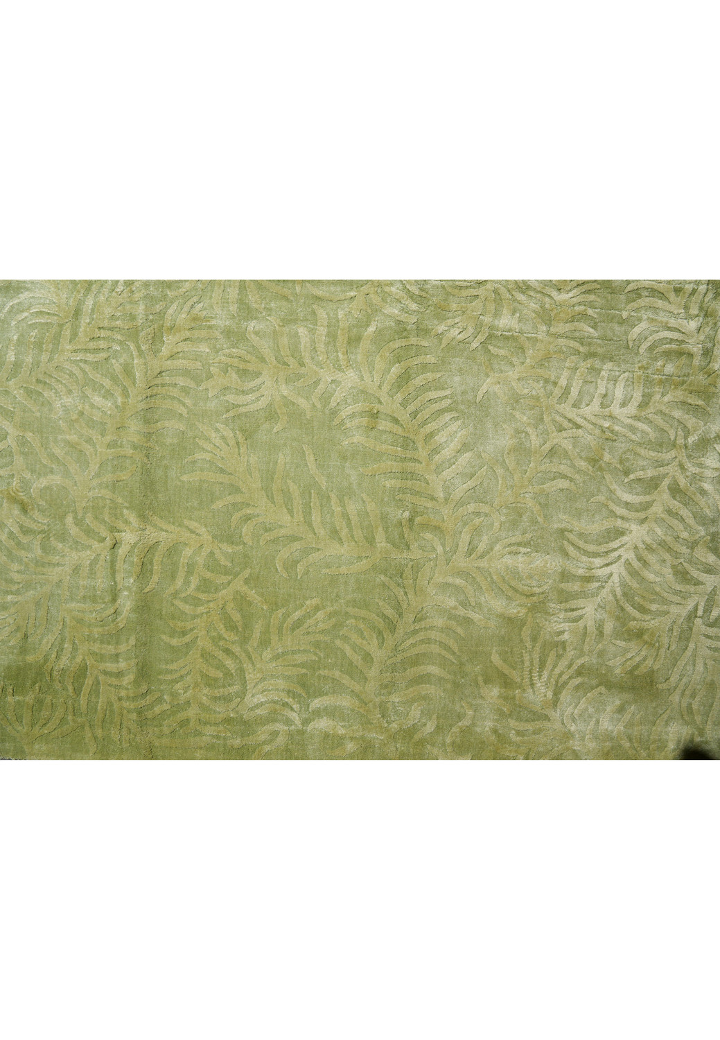 Close-up detail highlighting the organic leaf-inspired pattern and raised texture woven into this modern olive green rug.