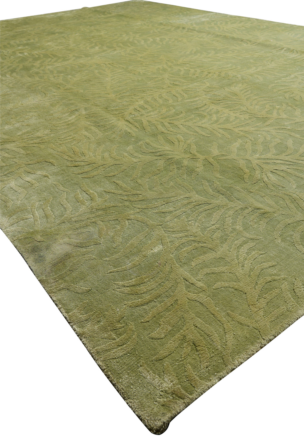 Angled perspective showing the sculpted surface and natural sheen of a modern olive and sage green wool and silk rug.